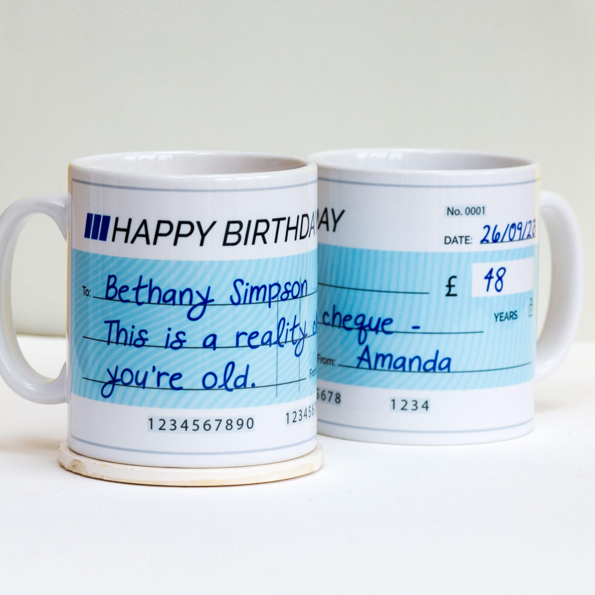 Funny Birthday Gift: Personalised mug with a cheque motif for a humorous touch.