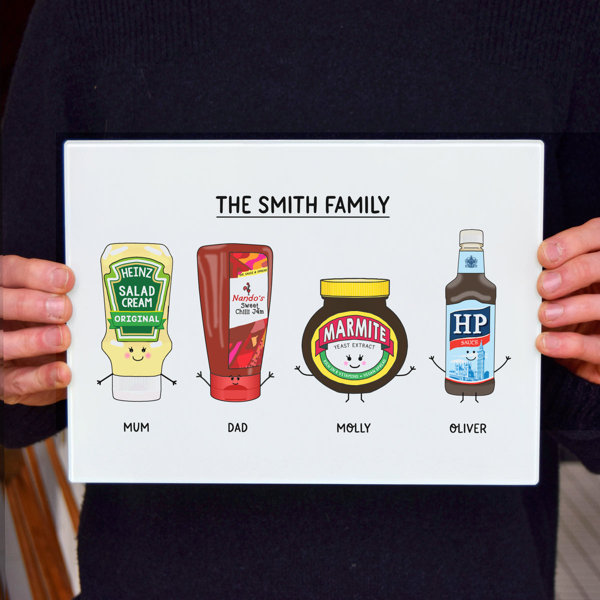 a person holding the personalised condiments glass chopping board by Of Life & Lemons to get an idea of scale