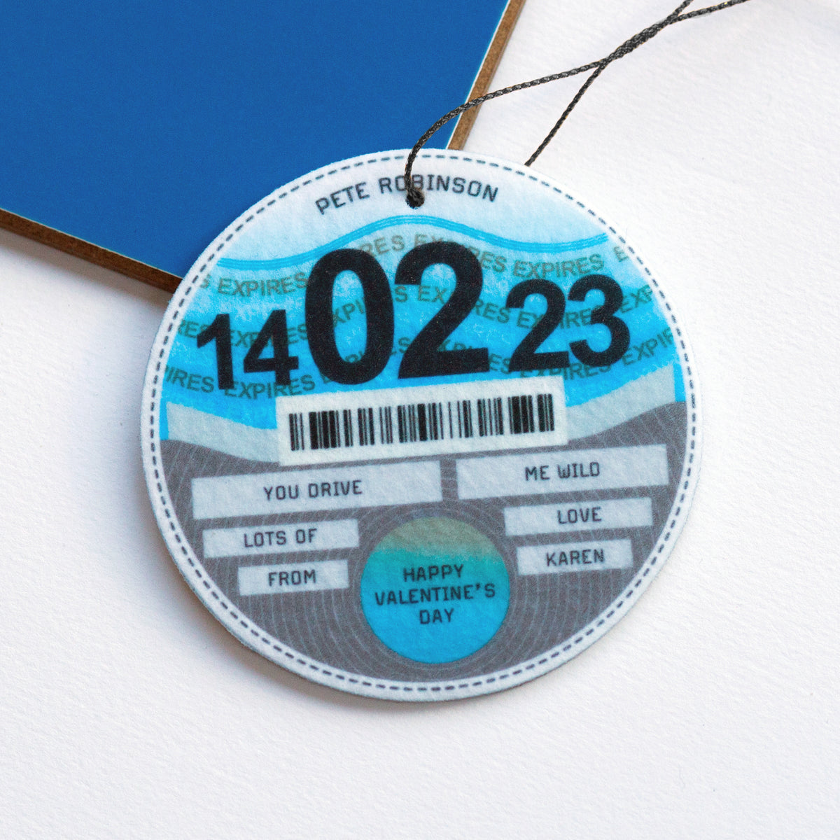 Car air freshener designed to look like a tax disc